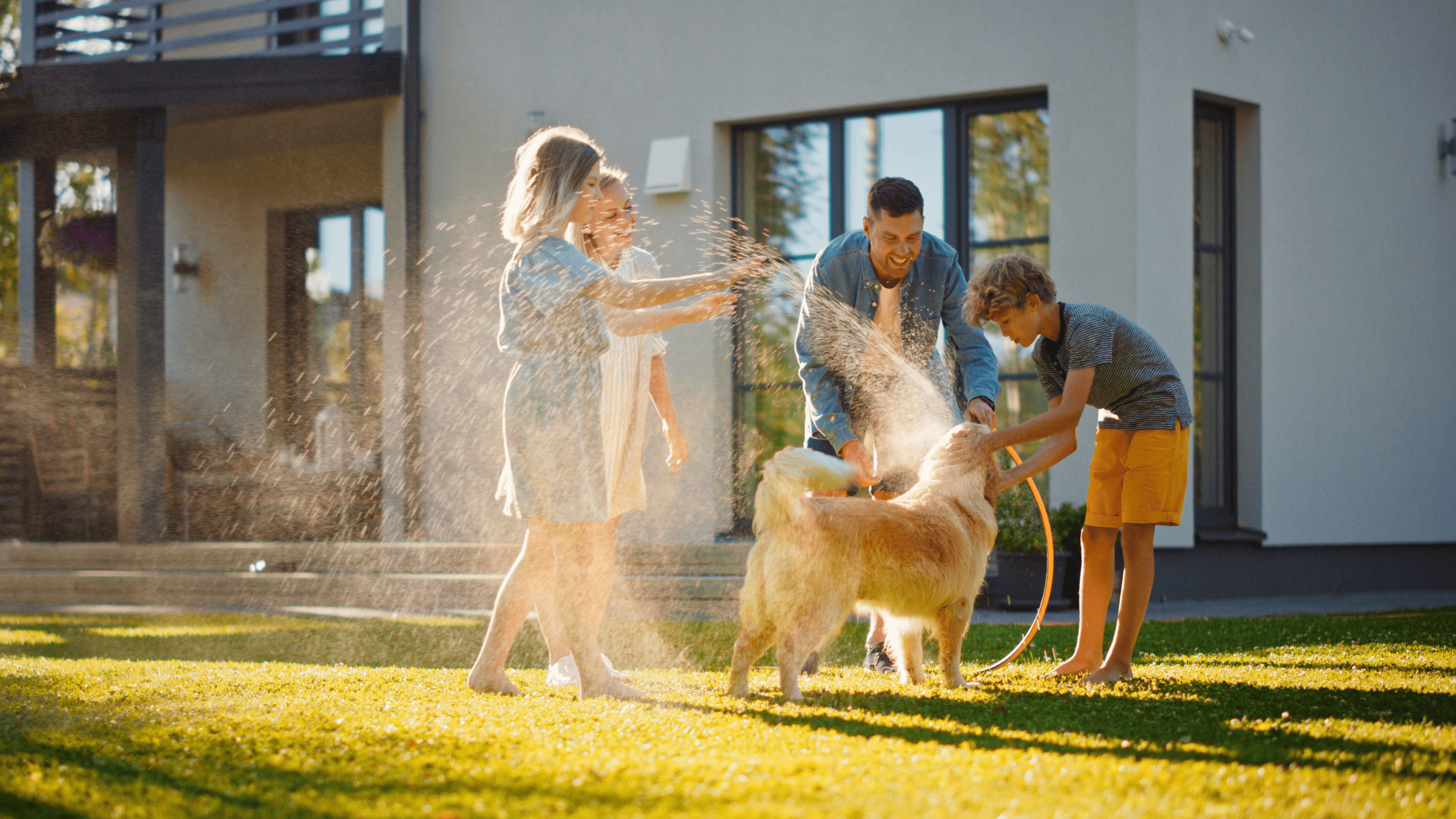 Family playing in their backyard with their dog after Scoopie Utah pooper scooper service visit